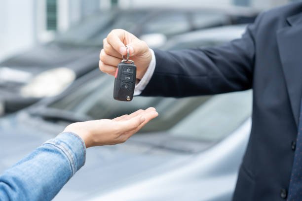 BDC Outsourcing team handing car key to customer during test drive appointment